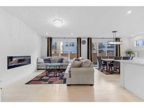 273 Ambleside Avenue Nw, Calgary, AB - Indoor Photo Showing Living Room With Fireplace