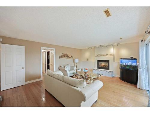 1711 Meadowlark Road Se, Airdrie, AB - Indoor Photo Showing Living Room With Fireplace