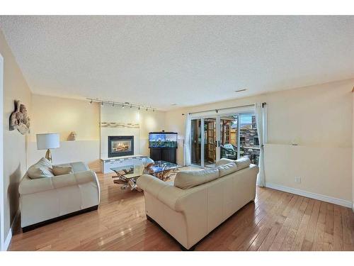 1711 Meadowlark Road Se, Airdrie, AB - Indoor Photo Showing Living Room With Fireplace