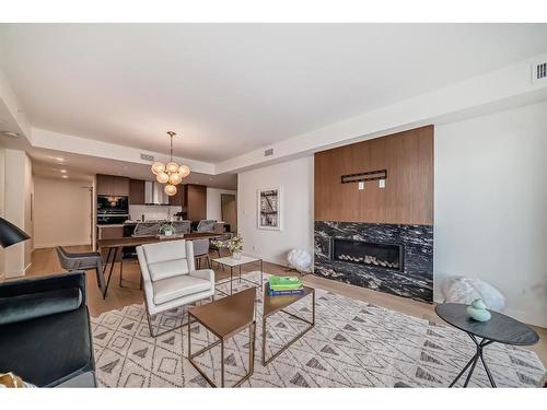 201-128 Waterfront Court Sw, Calgary, AB - Indoor Photo Showing Living Room With Fireplace