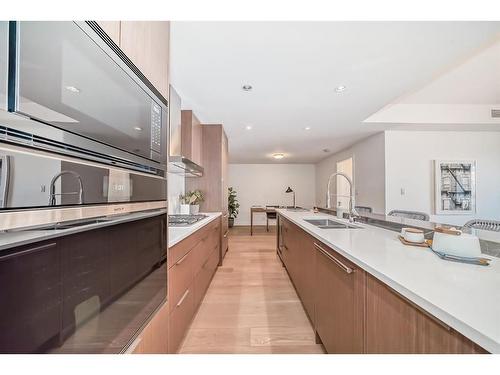 201-128 Waterfront Court Sw, Calgary, AB - Indoor Photo Showing Kitchen With Double Sink