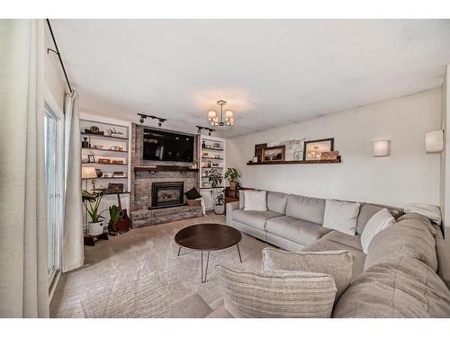 96 Glenhill Drive, Cochrane, AB - Indoor Photo Showing Living Room With Fireplace