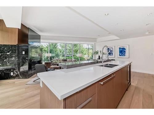 103-128 Waterfront Court Sw, Calgary, AB - Indoor Photo Showing Kitchen With Double Sink