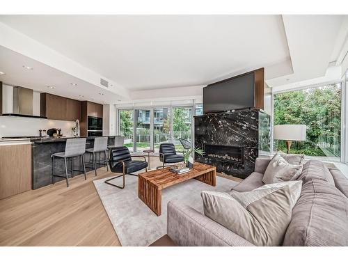 103-128 Waterfront Court Sw, Calgary, AB - Indoor Photo Showing Living Room With Fireplace