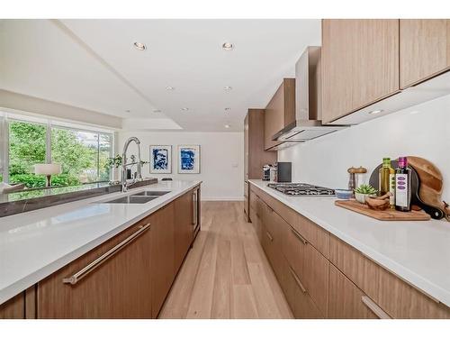 103-128 Waterfront Court Sw, Calgary, AB - Indoor Photo Showing Kitchen With Double Sink