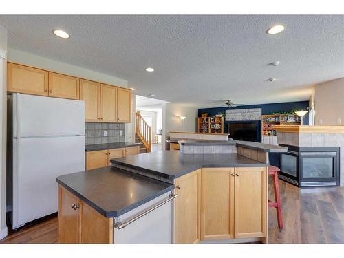 130 Edgeridge Circle Nw, Calgary, AB - Indoor Photo Showing Kitchen With Fireplace