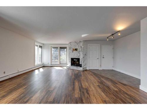 303-350 4 Avenue Ne, Calgary, AB - Indoor Photo Showing Living Room With Fireplace