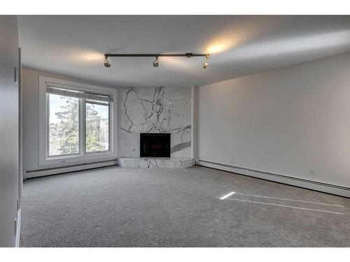 303-350 4 Avenue Ne, Calgary, AB - Indoor With Fireplace