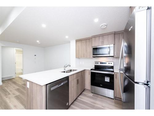 212 Lucas Common Nw, Calgary, AB - Indoor Photo Showing Kitchen With Double Sink