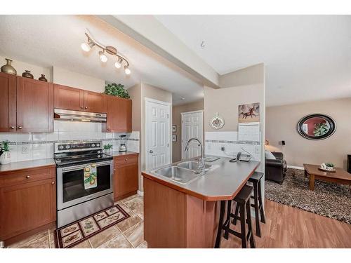 3-102 Canoe Square Sw, Airdrie, AB - Indoor Photo Showing Kitchen With Double Sink