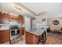 3-102 Canoe Square Sw, Airdrie, AB  - Indoor Photo Showing Kitchen With Double Sink 