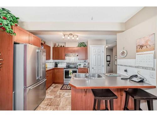 3-102 Canoe Square Sw, Airdrie, AB - Indoor Photo Showing Kitchen With Stainless Steel Kitchen