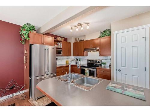 3-102 Canoe Square Sw, Airdrie, AB - Indoor Photo Showing Kitchen With Stainless Steel Kitchen With Double Sink