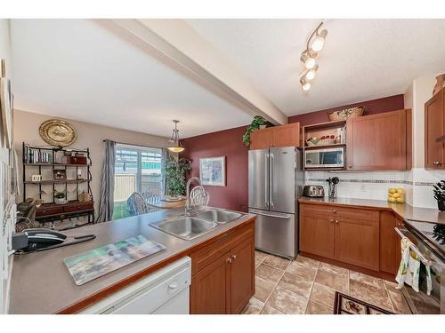 3-102 Canoe Square Sw, Airdrie, AB - Indoor Photo Showing Kitchen With Double Sink