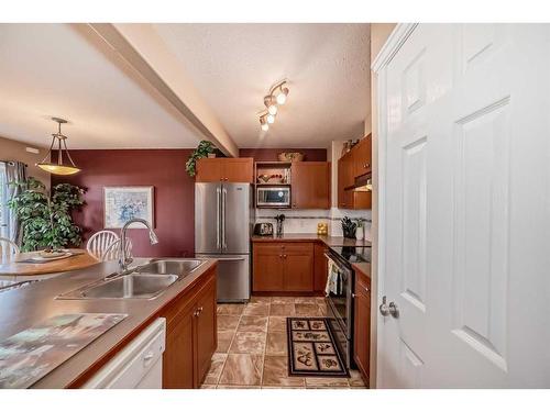 3-102 Canoe Square Sw, Airdrie, AB - Indoor Photo Showing Kitchen With Double Sink