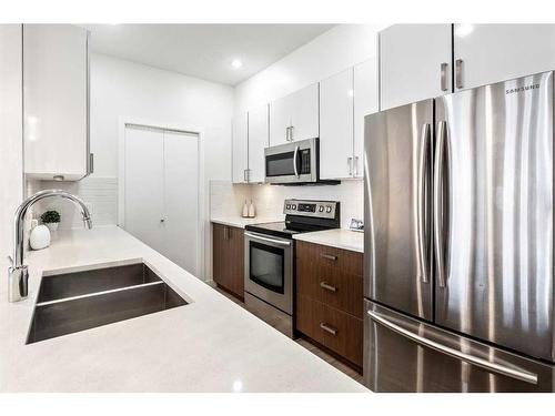 301-28 Auburn Bay Link Se, Calgary, AB - Indoor Photo Showing Kitchen With Stainless Steel Kitchen With Double Sink With Upgraded Kitchen