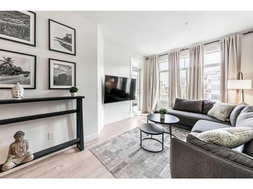 301-28 Auburn Bay Link Se, Calgary, AB - Indoor Photo Showing Living Room With Fireplace