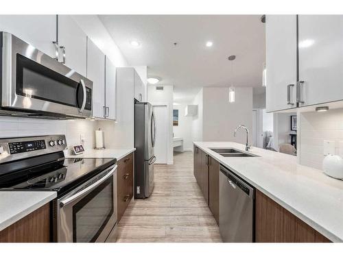 301-28 Auburn Bay Link Se, Calgary, AB - Indoor Photo Showing Kitchen With Stainless Steel Kitchen With Double Sink With Upgraded Kitchen