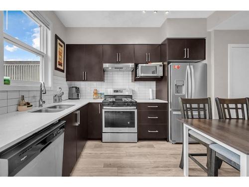 202-415 Redstone Walk Ne, Calgary, AB - Indoor Photo Showing Kitchen With Double Sink