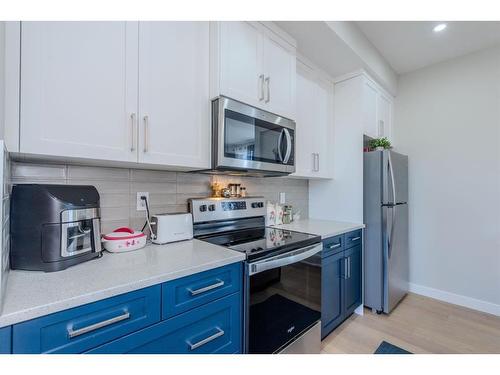 1187 Lanark Boulevard Se, Airdrie, AB - Indoor Photo Showing Kitchen With Stainless Steel Kitchen With Upgraded Kitchen