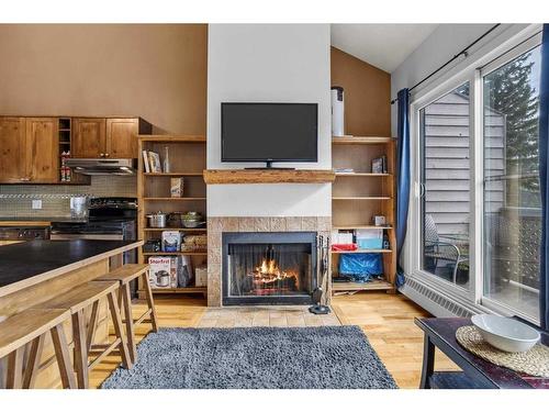 306-414 Squirrel Street, Banff, AB - Indoor Photo Showing Other Room With Fireplace