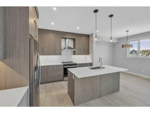 219 Dawson Wharf Rise, Chestermere, AB - Indoor Photo Showing Kitchen With Double Sink With Upgraded Kitchen