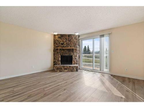 7008B Bowness Road Nw, Calgary, AB - Indoor Photo Showing Living Room With Fireplace