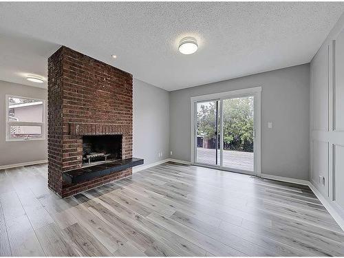 104 Oakfield Place Sw, Calgary, AB - Indoor Photo Showing Living Room With Fireplace