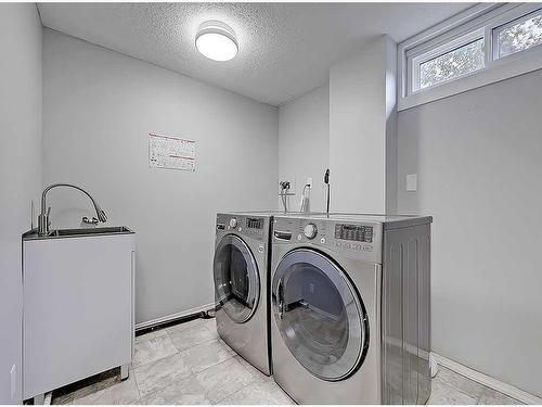 104 Oakfield Place Sw, Calgary, AB - Indoor Photo Showing Laundry Room