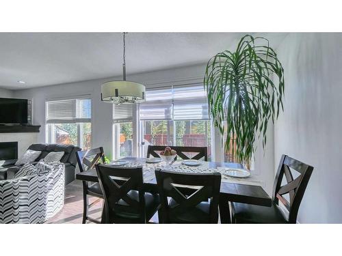 127 Evanswood Circle Nw, Calgary, AB - Indoor Photo Showing Dining Room With Fireplace