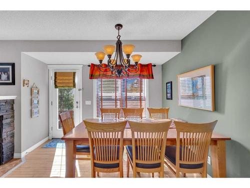 113 West Lakeview Crescent, Chestermere, AB - Indoor Photo Showing Dining Room With Fireplace