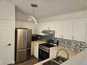 25 Martinvalley Road Ne, Calgary, AB  - Indoor Photo Showing Kitchen With Double Sink 