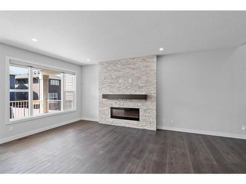 275 Seton Road Se, Calgary, AB - Indoor Photo Showing Living Room With Fireplace