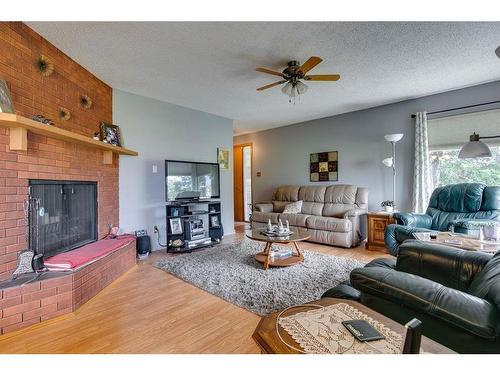 271058 Range Road 22, Rural Rocky View County, AB - Indoor Photo Showing Living Room With Fireplace