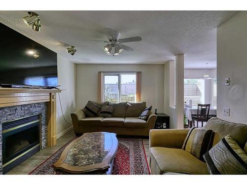 250 Coral Keys Court Ne, Calgary, AB - Indoor Photo Showing Living Room With Fireplace