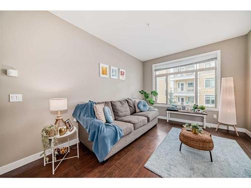 306-22 Auburn Bay Link Se, Calgary, AB - Indoor Photo Showing Living Room With Fireplace