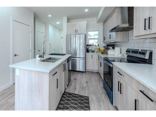 106-116 Saddlestone Heath Ne, Calgary, AB - Indoor Photo Showing Kitchen With Stainless Steel Kitchen With Double Sink With Upgraded Kitchen