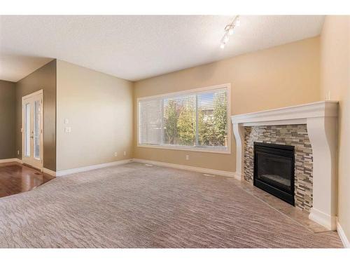 135 Kincora Drive Nw, Calgary, AB - Indoor Photo Showing Living Room With Fireplace