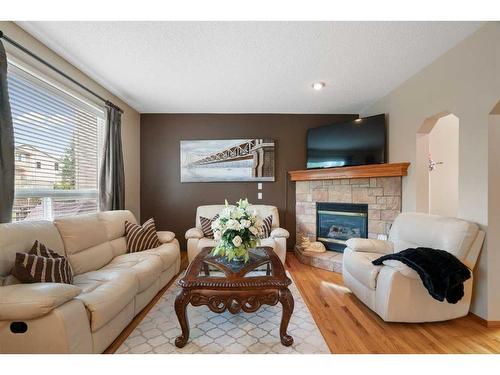 192 Eversyde Way Sw, Calgary, AB - Indoor Photo Showing Living Room With Fireplace