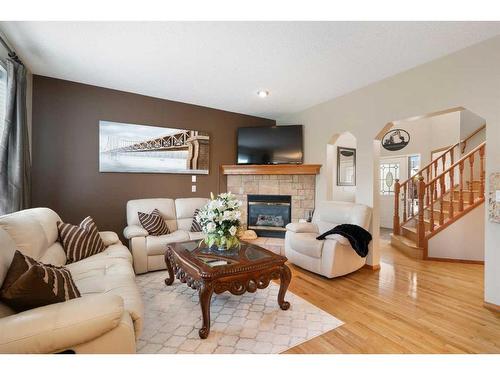 192 Eversyde Way Sw, Calgary, AB - Indoor Photo Showing Living Room With Fireplace