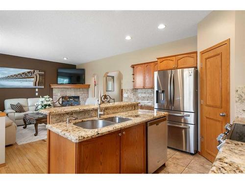 192 Eversyde Way Sw, Calgary, AB - Indoor Photo Showing Kitchen With Fireplace With Double Sink