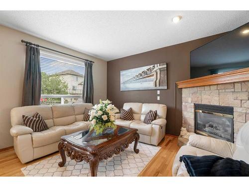 192 Eversyde Way Sw, Calgary, AB - Indoor Photo Showing Living Room With Fireplace