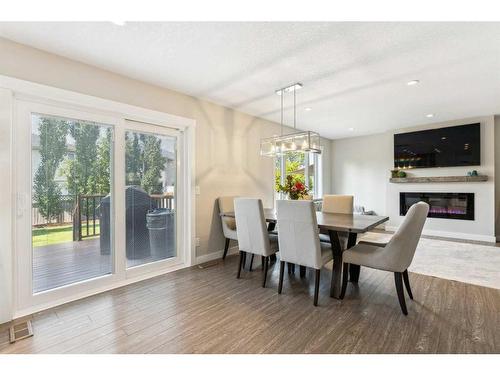 573 Douglas Woods Mews Se, Calgary, AB - Indoor Photo Showing Dining Room With Fireplace