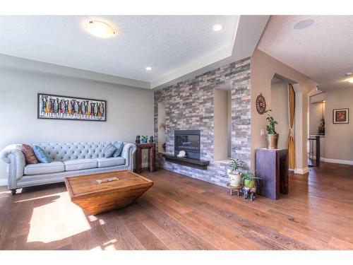 13 Marquis View Se, Calgary, AB - Indoor Photo Showing Living Room With Fireplace