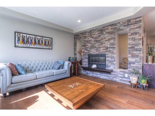 13 Marquis View Se, Calgary, AB - Indoor Photo Showing Living Room With Fireplace