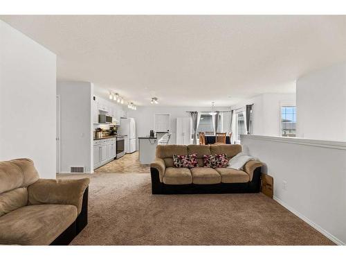 12 Mackenzie Way, Carstairs, AB - Indoor Photo Showing Living Room