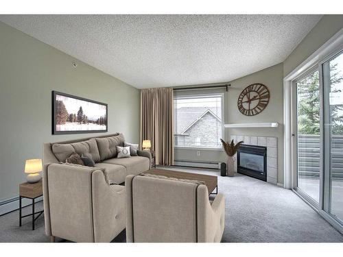 2202-2000 Millrise Point Sw, Calgary, AB - Indoor Photo Showing Living Room With Fireplace