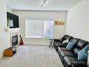 56 Bridleridge Manor  Sw, Calgary, AB  - Indoor Photo Showing Living Room With Fireplace 