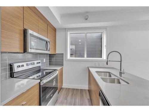 19625 45 Street Se, Calgary, AB - Indoor Photo Showing Kitchen With Double Sink