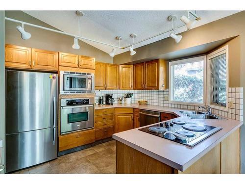 938 Suncastle Drive Se, Calgary, AB - Indoor Photo Showing Kitchen With Double Sink